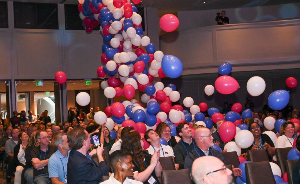 Balloons falling down on people seated in chairs